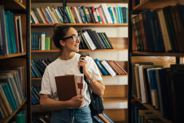 istock A student stuying and reading books in a public library. 1519148628