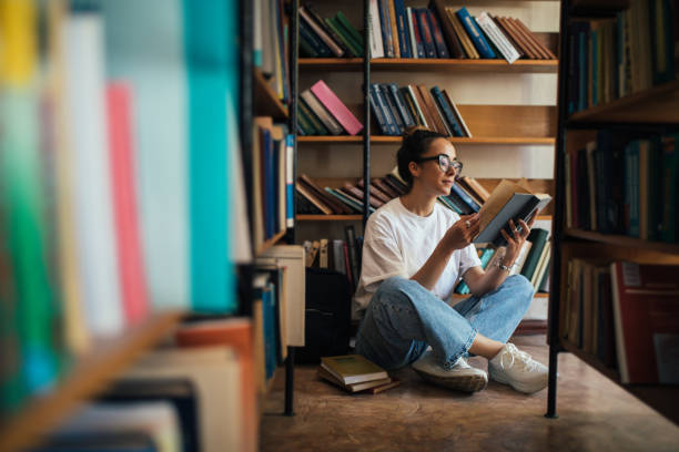 istock A student stuying and reading books in a public library. 1519148634