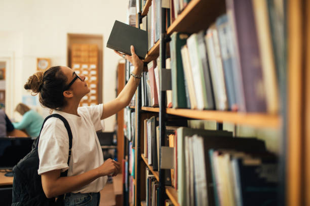 istock A student stuying and reading books in a public library. 1519148644