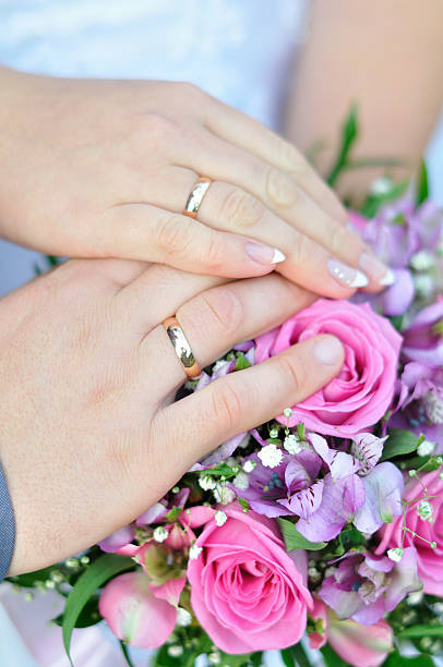 istock bridal bouquet and hands with rings 151915208