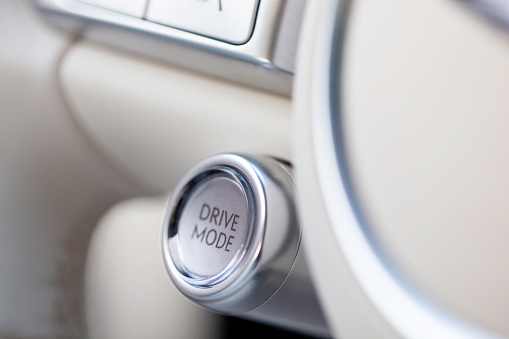 A Drive Mode button in a car interior that provides more power for a limited time.
