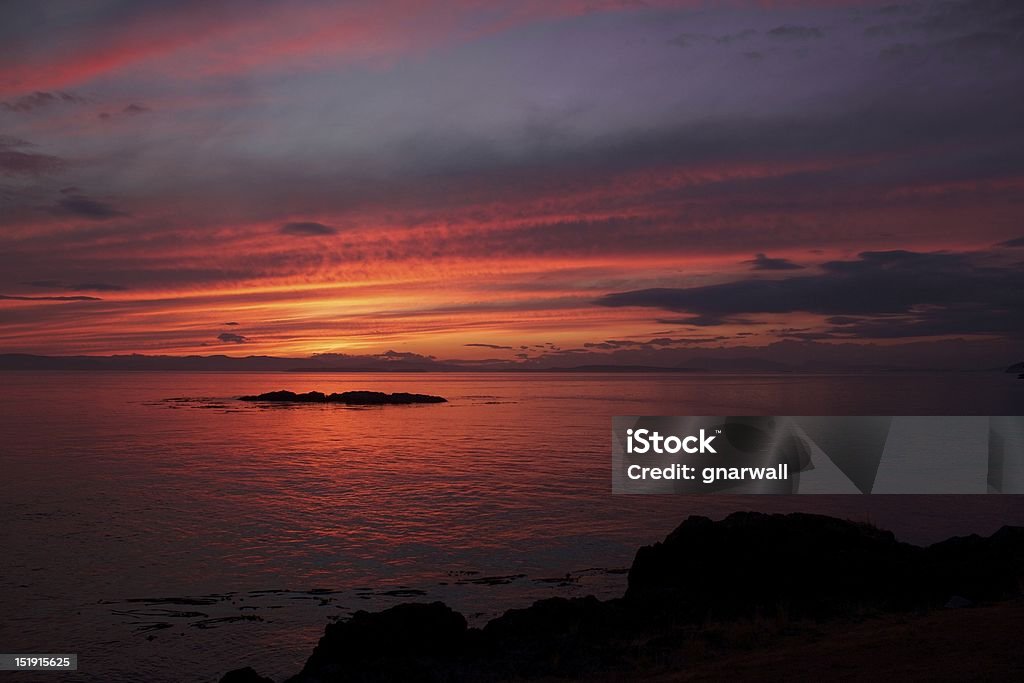 San Juan Island Sunset A beautiful sunset on the western side of Washington State's famous San Juan Island. The island is a classic tourism location, made famous for its orca whales, calming atmosphere, and beautiful scenery. Horizontal Stock Photo