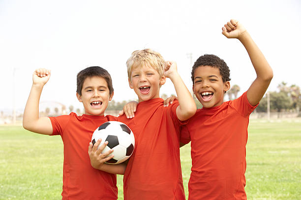 istock Young Boys In Football Team Celebrating 151915719