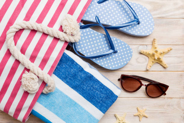 istock beach accessories flat lay top view on colored background Summer travel concept. Bag with starfish and sea shell. Top view 1519157522