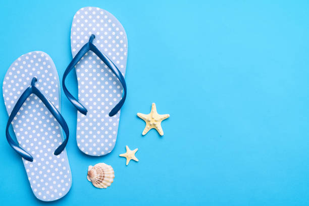 istock Flat lay composition with flip flops and seashell on colored background. Space for text top view 1519157770