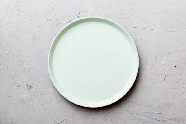 istock Top view of empty blue plate on cement background. Empty space for your design 1519157939