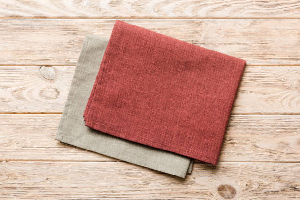 istock top view with red empty kitchen napkin isolated on table background. Folded cloth for mockup with copy space, Flat lay. Minimal style 1519158496
