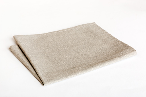top view with gray kitchen napkin isolated on table background. Folded cloth for mockup with copy space, Flat lay. Minimal style.
