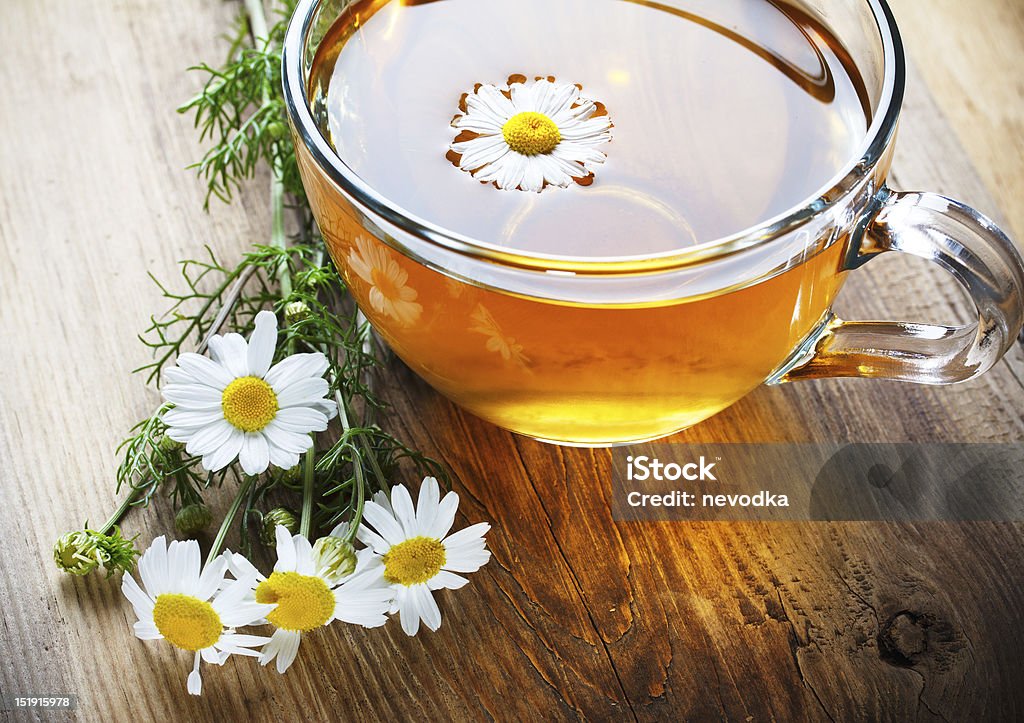 chamomile tea on wooden table herbal chamomile tea on wooden table Brown Stock Photo