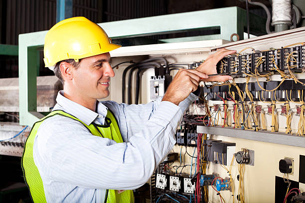 electrician reapairing industrial machine male electrician reapairing industrial machine control component electrician smiling stock pictures, royalty-free photos & images