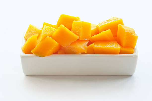 Mango Cubes on a white dish stock photo