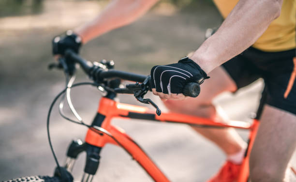 istock Hands in gloves on bike handlebar 1519162804