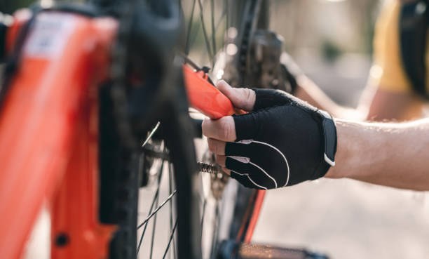 istock Cyclist checking mechanism on bicycle 1519162824