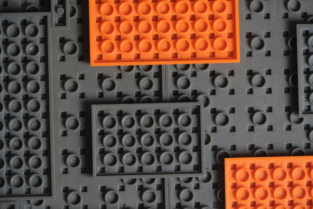 istock Abstract gray orange background from plastic building block children designer. 1519183171