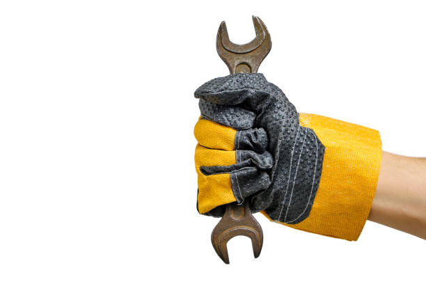 istock Builder gloved hand holding wrenches white background.Concept for Labor Day first May. 1519183198