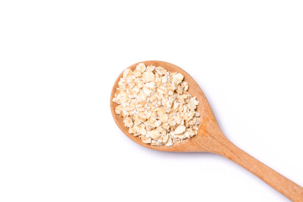 istock Oat flakes in wooden spoon isolated on white 1519199144