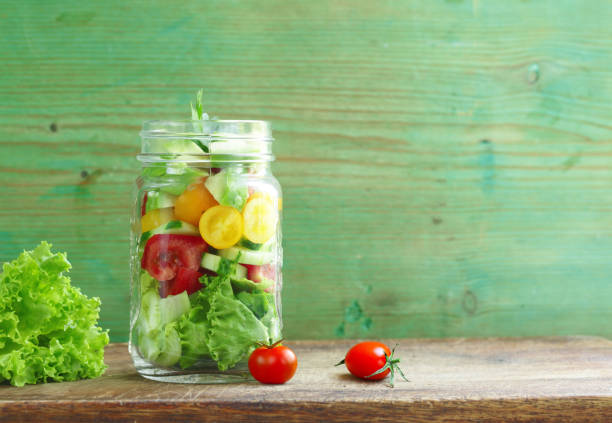 fresh salad in a jar with tomatoes and lettuce
