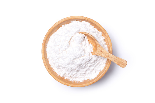 White powder in wooden bowl isolated on white background with clipping path.