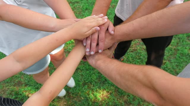 Joined hands as a team. Business teamwork. Close up group of multiracial friends meeting join hands together. Diversity people. Partnership volunteer community. Diverse multiethnic Partners. Top View