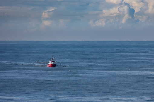 A cutter with lifted drag nets on the North sea