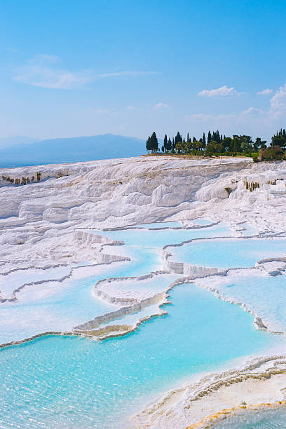 Travertines in Pamukkale, Turkey Carbonate travertines with blue water - unique nature wonder in Pamukkale, Turkey denizli stock pictures, royalty-free photos & images