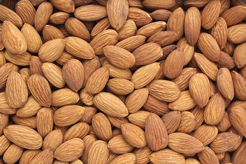 Almond nuts on canvas background. Healthy diet, nutrition, vegan concept. Protein dry organic snack. Raw food