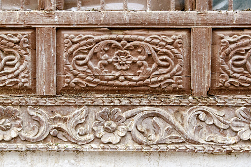 Jeddah, Saudi Arabia - December 21, 2022: Street life in the Old City. The unique architecture of the medieval Arab city. Historic Jeddah. Woodcarving. Fragment of the decoration of the facade of the house.