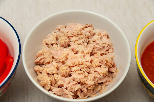 istock Tuna in bowl in top view isolated on light background 1519277916