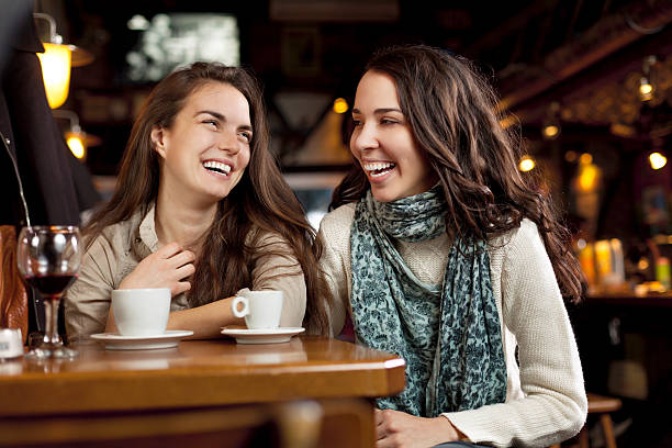 istock Young girls laughing in a cafe bar 151929423