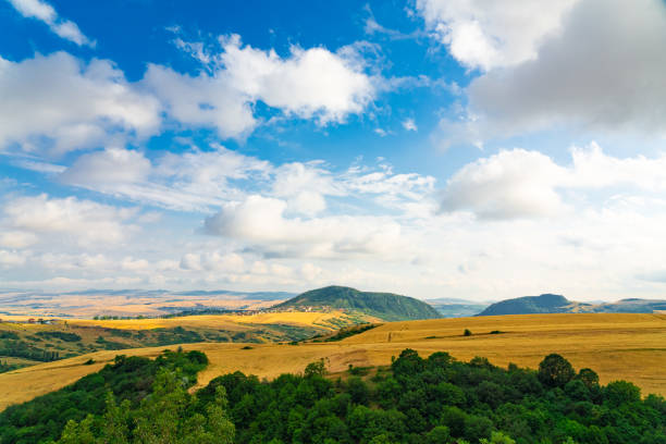 Meadow and view of the Balaton Uplands (with Szent György Hill) from Csobánc Hill at sunrise in springtime.