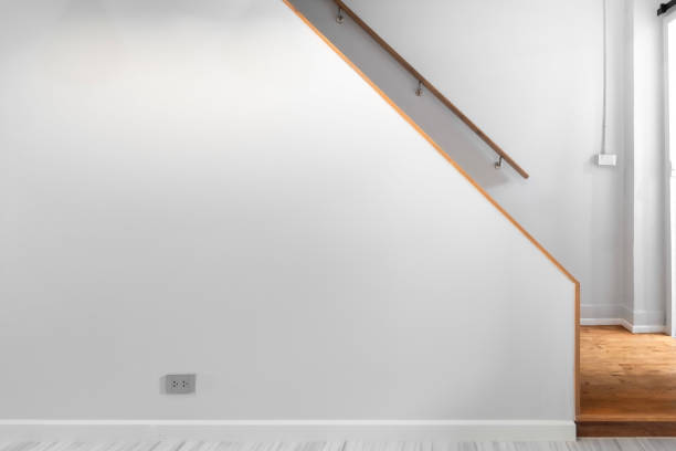 modern white staircase going up with natural wood steps and handrails in minimal house