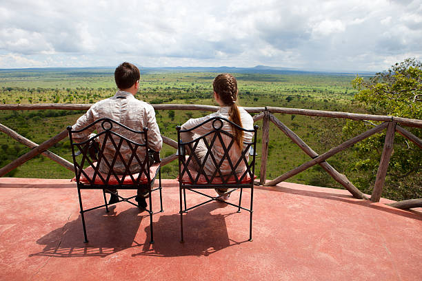 Couple on balcony of safari lodge stock photo