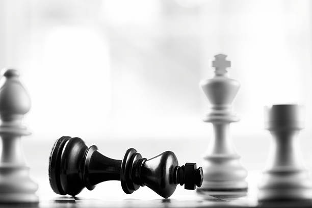 istock Fallen black king chess piece next to white king 151933223