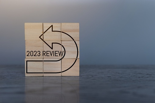 Wooden cubes with text 2023 REVIEW. Copy space for text. Annual review, evaluation and audit concept