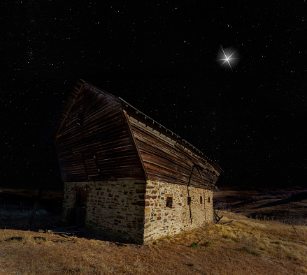 Old barn on Christmas Eve with a star shining brightly above