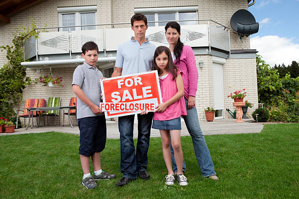 istock Young family holding a foreclosure sign 151934235