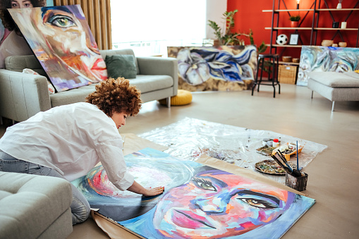 Woman painting in her art studio at home
