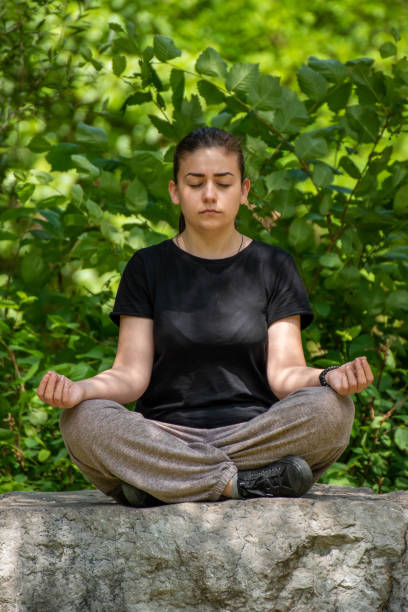 istock Girl meditating on stone 1519355343
