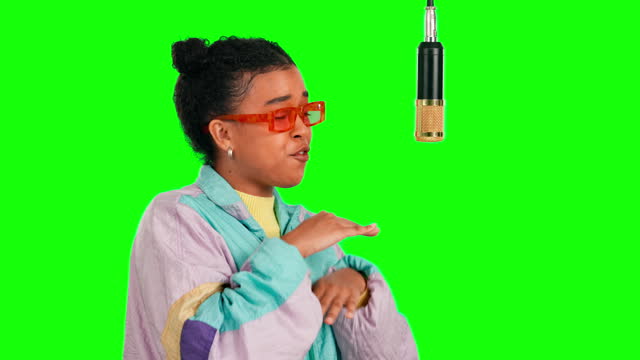 Green screen microphone, rapper and woman singing song, recording voice track, hip hop music and singer performance. Retro musician, chroma key artist and gen z female rap on radio studio background