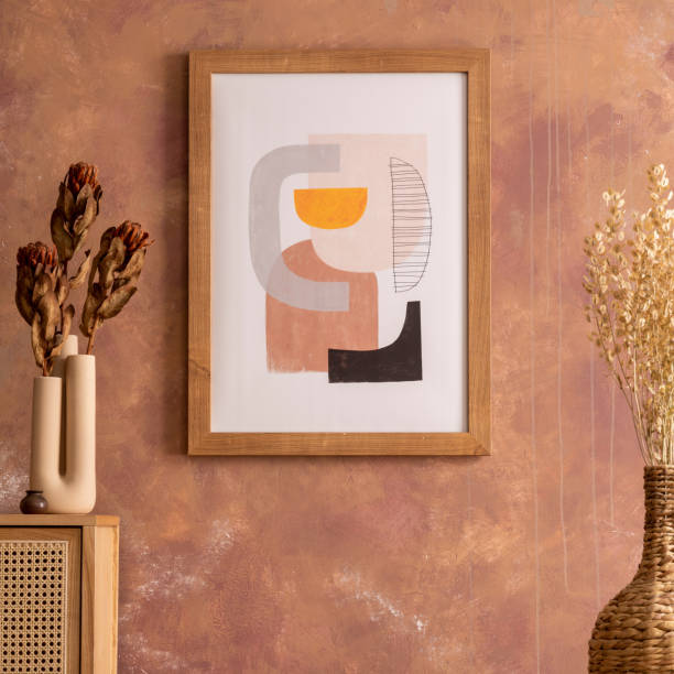 istock Boho vintage dining room interior with poster mock up. Round table with rattan chair, commode and flowers. Brown wall and rattan lamp. Mock up poster. Template. 1519355481