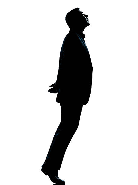 istock one business man silhouette tiptoe looking up 151935741