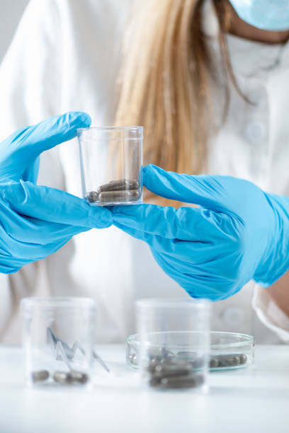 istock Scientist Holding Fecal Transplant Caps in Lab 1519366403