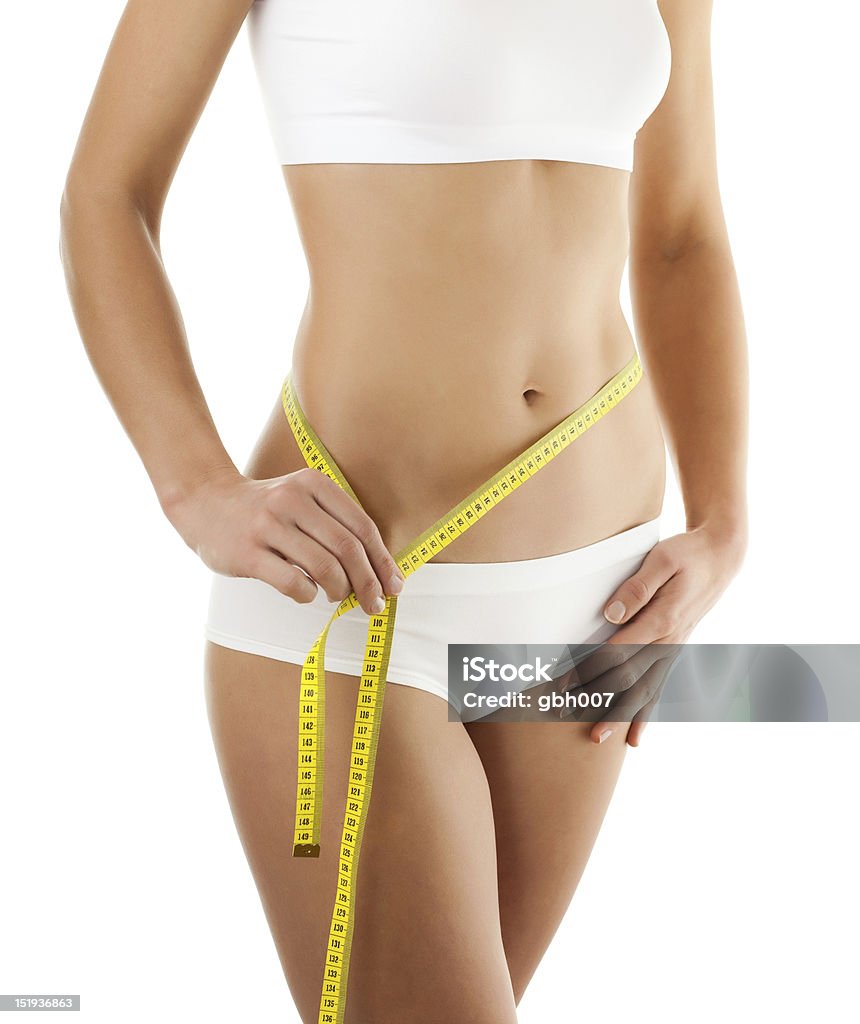 Donna misura il Suo corpo isolato su bianco - Foto stock royalty-free di Abbigliamento intimo