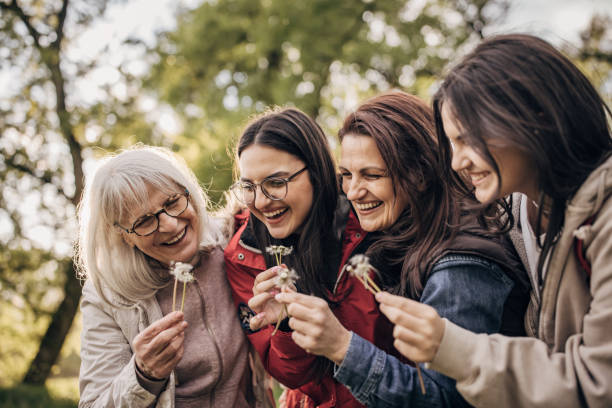 istock Women blowing dandelion 1519369180
