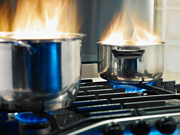 home disasters pans in fire on stoves. Horizontal shape kitchen on fire stock pictures, royalty-free photos & images