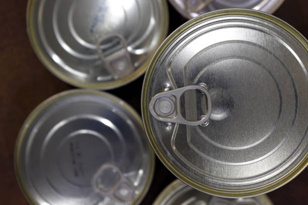 istock Close-up of closed tin cans with a key to open them 1519374491