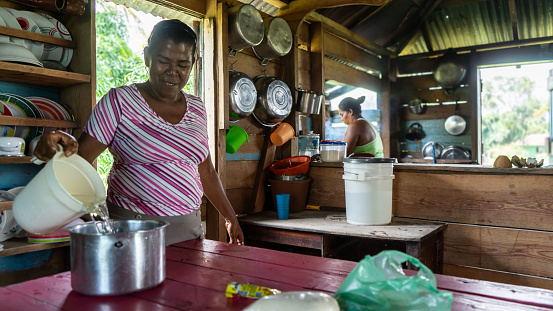 Afro-descendant Caribbean woman cooking with pure water in her humble home in the northern Caribbean of Nicaragua