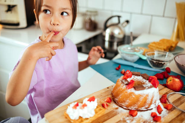 Girl enjoying cake in the kitchen