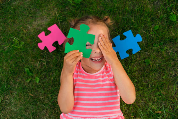 istock A ludicrous child is playing with puzzles while lying on the lawn grass 1519386906