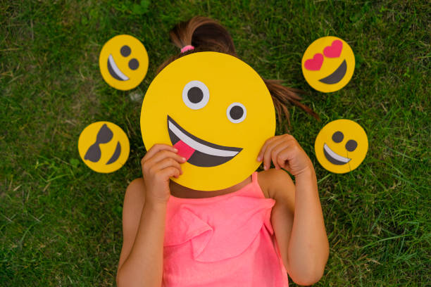 istock A woman hides her face behind emojis making faces 1519387412
